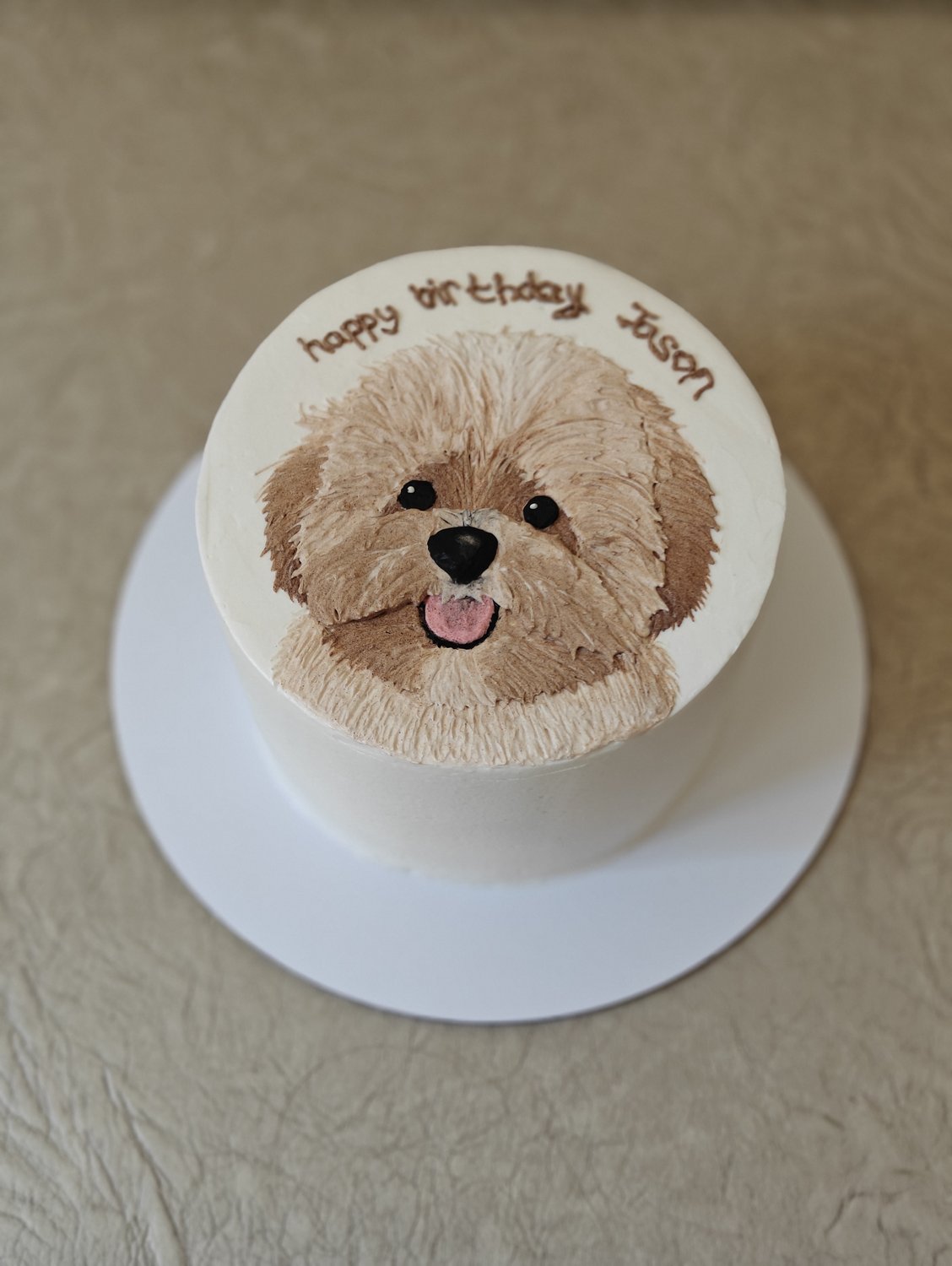 Personalized puppy portrait piped onto ivory cake